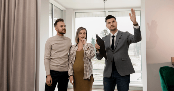 estate-agent-showing-couple-a-house