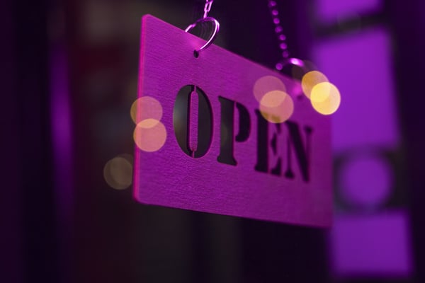 open-sign-hanging-with-purple-light